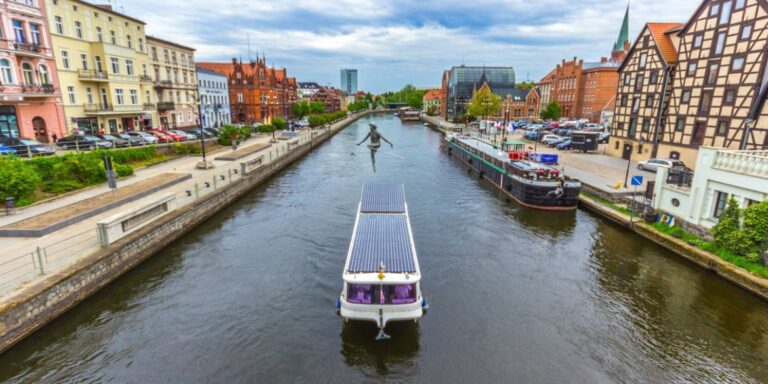 Sightseeing boat approaching a lock on the Brda River in Bydgoszcz, Poland.